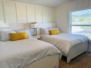 Bedroom featuring a decorative wall and multiple windows