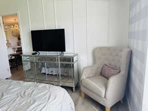 Bedroom featuring a chandelier and wood finished floors