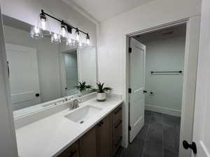 Bathroom with tile patterned floors, visible vents, and vanity