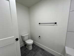 Bathroom with toilet and baseboards