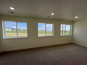 Empty room featuring recessed lighting, baseboards, visible vents, and carpet