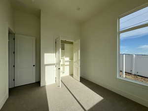 Unfurnished bedroom with carpet floors, baseboards, and a closet
