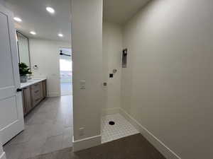 Laundry area with light tile patterned floors, baseboards, a sink, hookup for a washing machine, and recessed lighting