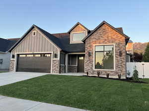 View of front of house with board and batten siding, a garage, concrete driveway, and a shingled roof