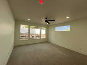 Spare room featuring recessed lighting, baseboards, and carpet