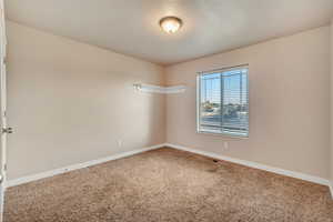 View of carpeted main level bedroom