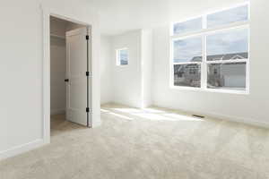 Unfurnished bedroom featuring light carpet