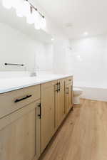 Full bathroom featuring vanity, shower / bathtub combination, toilet, and hardwood / wood-style flooring