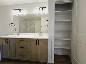 Bathroom with vanity, hardwood / wood-style floors, and walk in shower