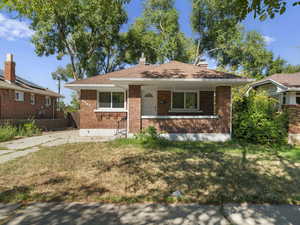 View of front of house with a front lawn and covered porch