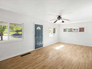 Foyer with light wood-type flooring, a healthy amount of sunlight, and ceiling fan