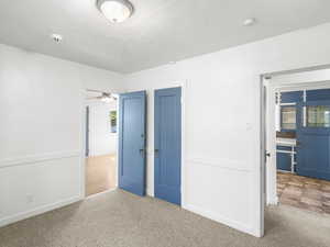 Unfurnished bedroom with a textured ceiling and carpet flooring