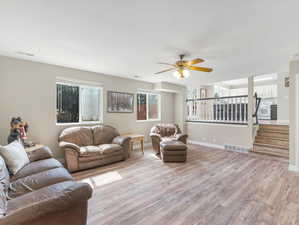 Living room featuring ceiling fan and light hardwood / wood-style floors