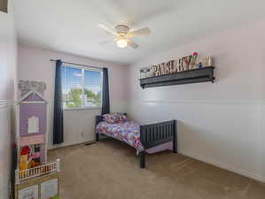 Carpeted bedroom with ceiling fan