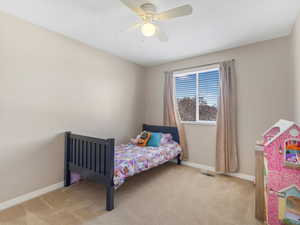 Bedroom featuring light colored carpet and ceiling fan