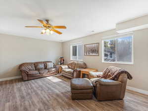 Living room featuring wood-type flooring and ceiling fan