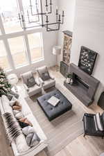 Living room with a notable chandelier and hardwood / wood-style floors