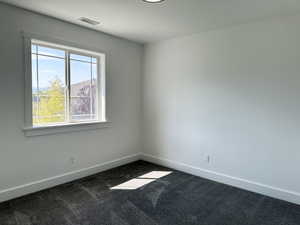 Third bedroom featuring carpet floors, nice closet and a big window