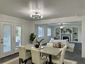 Inviting great room featuring ceiling fan, gas fireplace together with the dining area.