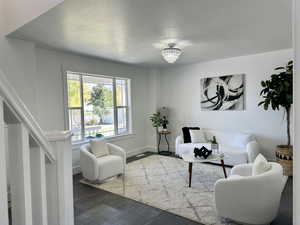 Spacious living room featuring plenty of light, easy access to great room and upstairs