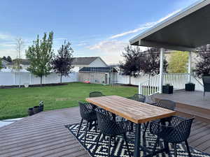 Composite deck with a lawn, swings, shed and playhouse in a beautifully landscaped yard