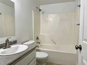 Full bathroom with vanity, toilet, shower / tub combination, and tile patterned flooring