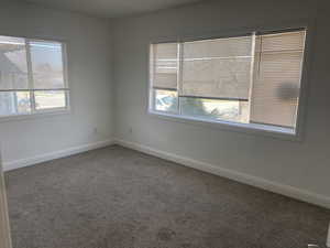 Spare room featuring carpet flooring