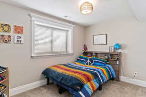 Carpeted bedroom with a textured ceiling