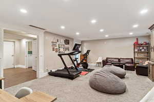 Workout area with washer / dryer and wood-type flooring