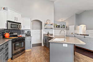 Kitchen featuring light hardwood / wood-style flooring, sink, gray cabinetry, appliances with stainless steel finishes, and white cabinets