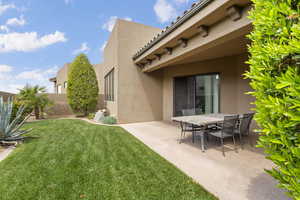 View of yard with fence, outdoor dining space, and a patio area