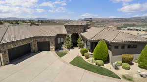 Mediterranean / spanish-style home featuring stucco siding, a tiled roof, stone siding, concrete driveway, and a 6 Car attached garage