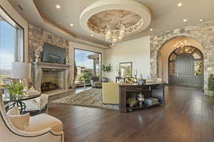 Interior space with a notable chandelier, a raised ceiling, and plenty of natural light
