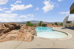 Outdoor pool with a patio and a mountain view