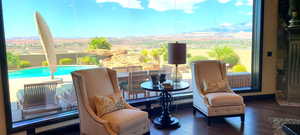 Living area with a mountain view, dark hardwood / wood-style flooring, and a healthy amount of sunlight