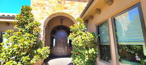 Striking entrance to property with beautiful wood doors.