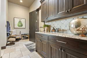 Interior space featuring stone tile floors and recessed lighting