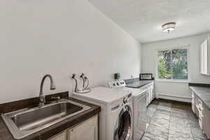 Main floor laundry with sink and built-in cabinets