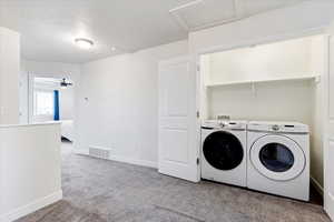 Closet laundry with shelf for storage.