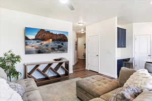 Family/living room with laminate flooring, picture window and back door to fenced patio.