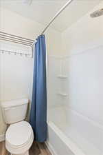 Bathroom featuring vanity and laminate floors with separate water closet.