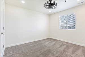 Carpeted  bedroom with ceiling fan.