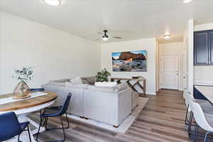 Family/living room with laminate flooring, picture window and back door to fenced patio.