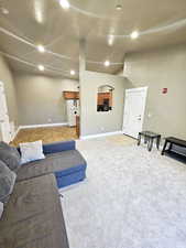 Carpeted living room featuring a textured ceiling