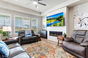 Living room featuring light wood-type flooring and ceiling fan