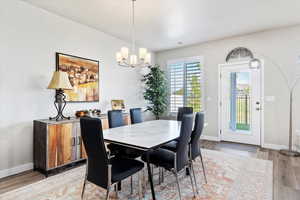 Dining room with hardwood / wood-style floors and a chandelier