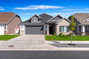 Craftsman inspired home with a garage and a front yard