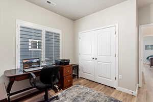 Office area with light hardwood / wood-style floors