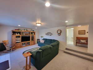 Carpeted living room with a textured ceiling