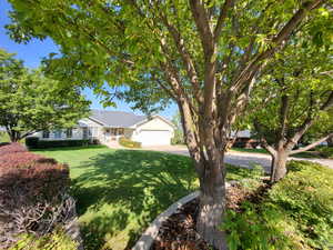 View of front of house with a front lawn and a garage